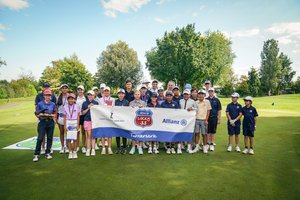 Gruppenfoto mit 20 Kindern auf Wiese mit vorgehaltenemLucky33 Banner